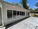 A sunroom adjacent to the pool area features multiple large windows, with a concrete patio area at 1329 Se 36Th Ave, Ocala, FL 34471