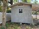 Backyard shed with a covered patio area adjacent to a fenced-in yard at 1329 Se 36Th Ave, Ocala, FL 34471