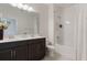 Clean bathroom with a double vanity, dark wood cabinets and a shower-tub combination at 13748 Werrington Dr, Winter Garden, FL 34787