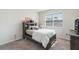 Stylized bedroom with a comfortable bed, shelving headboard and window at 13748 Werrington Dr, Winter Garden, FL 34787