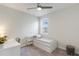 Comfortable bedroom with a daybed, desk, ceiling fan and natural light from the window at 13748 Werrington Dr, Winter Garden, FL 34787