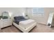 Bright bedroom with a white bed frame, matching dressers, and ample natural light from the window at 13748 Werrington Dr, Winter Garden, FL 34787