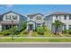 Charming two-story home with a well-manicured lawn and tropical landscaping at 13748 Werrington Dr, Winter Garden, FL 34787