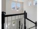 View from the top of the staircase down to the entryway and the front door at 13748 Werrington Dr, Winter Garden, FL 34787