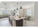 Bright and open kitchen with an island, pendant lights, and sightlines to dining and living areas at 13748 Werrington Dr, Winter Garden, FL 34787