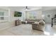 Bright living room featuring a large gray sectional sofa, and a wall-mounted TV at 13748 Werrington Dr, Winter Garden, FL 34787