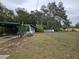 Property featuring a chain link fence and mature trees, offering privacy at 1424 Lake Shore Dr, Casselberry, FL 32707