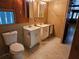 Bathroom with dual sink vanities, a toilet and natural light from window at 1424 Lake Shore Dr, Casselberry, FL 32707