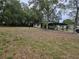 The full backyard showcasing ample space and mature trees offering privacy and shade at 1424 Lake Shore Dr, Casselberry, FL 32707