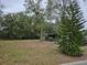 Expansive front yard with mature trees and lush greenery, perfect for outdoor activities and relaxation at 1424 Lake Shore Dr, Casselberry, FL 32707