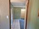 Hallway showing neutral-colored walls and tile flooring leading to other rooms at 1424 Lake Shore Dr, Casselberry, FL 32707