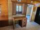 Wicker office desk with storage, set against the wall between the kitchen and living room at 1424 Lake Shore Dr, Casselberry, FL 32707
