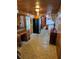 Kitchen with wood paneled walls, black refrigerator and view to laundry area at 1424 Lake Shore Dr, Casselberry, FL 32707