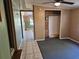 Living room with carpeted floor, ceiling fan, and view into the hallway with tiled floor at 1424 Lake Shore Dr, Casselberry, FL 32707