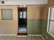 Living room with tan and green walls, tile floors, and a peek into the next room at 1424 Lake Shore Dr, Casselberry, FL 32707