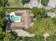 Stunning aerial view showcases a home with a private pool, circular driveway, and meticulously landscaped grounds at 1742 Barcelona Way, Winter Park, FL 32789