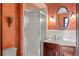 Bathroom featuring a shower with glass doors and a decorative mirror over a wooden vanity at 1742 Barcelona Way, Winter Park, FL 32789