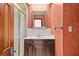 Bathroom with a marble countertop, dark wood cabinetry, and a shower with glass doors at 1742 Barcelona Way, Winter Park, FL 32789