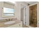 Bathroom with neutral countertop and vanity, shower, and view to a walk-in closet at 1742 Barcelona Way, Winter Park, FL 32789