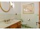 Bathroom featuring vintage green tile, marble sink, and gold accents at 1742 Barcelona Way, Winter Park, FL 32789
