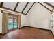 Bedroom features vaulted ceiling, hardwood floor, and access to a pool area at 1742 Barcelona Way, Winter Park, FL 32789