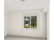 Bright bedroom with a large window overlooking lush greenery and neutral carpet at 1742 Barcelona Way, Winter Park, FL 32789