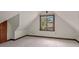 Cozy bedroom with angled ceilings, a window view, and neutral carpeting at 1742 Barcelona Way, Winter Park, FL 32789