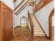 Open foyer featuring tiled floors, a staircase, wood details, and arched doorway leading to other rooms at 1742 Barcelona Way, Winter Park, FL 32789