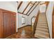 Home foyer showcasing tiled flooring, exposed beams, staircase, and natural light from a window at 1742 Barcelona Way, Winter Park, FL 32789