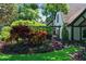 Beautifully landscaped front yard with colorful plants and a glimpse of the home's exterior at 1742 Barcelona Way, Winter Park, FL 32789