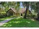 Charming home with well-manicured lawn and pathway leading to the front door, shaded by mature trees at 1742 Barcelona Way, Winter Park, FL 32789