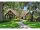 Charming home with well-manicured lawn and pathway leading to the front door, shaded by mature trees at 1742 Barcelona Way, Winter Park, FL 32789