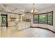Kitchen features white cabinetry, large bay window with green backyard view at 1742 Barcelona Way, Winter Park, FL 32789