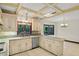 Bright kitchen with tiled countertops, white cabinets, and a coffered ceiling above the island at 1742 Barcelona Way, Winter Park, FL 32789