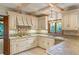 Classic kitchen features white cabinetry, tile countertops, and modern appliances at 1742 Barcelona Way, Winter Park, FL 32789