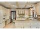 Kitchen has white cabinets and island and connects to another part of the home at 1742 Barcelona Way, Winter Park, FL 32789