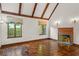 Bright living room with beamed ceilings, tile flooring, and a decorative fireplace at 1742 Barcelona Way, Winter Park, FL 32789