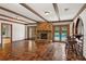 Entertainers living room with stone fireplace, tile flooring, and bar overlooking pool at 1742 Barcelona Way, Winter Park, FL 32789