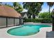 Lush backyard features a stunning pool, surrounded by greenery and adjacent to a well-maintained home exterior at 1742 Barcelona Way, Winter Park, FL 32789