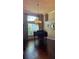 Bright dining room with hardwood floors, a piano, and a large window providing ample natural light at 1802 Hartford Path, The Villages, FL 32162