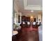 Open-concept kitchen featuring dark wood cabinets, a large island, and pendant lighting at 1802 Hartford Path, The Villages, FL 32162