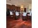 Well-appointed kitchen with dark wood cabinets, granite countertops, and a breakfast bar with seating at 1802 Hartford Path, The Villages, FL 32162