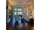 Elegant living room featuring hardwood floors, stylish furnishings, and abundant natural light at 1802 Hartford Path, The Villages, FL 32162