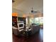 Bright living room has a tray ceiling, fireplace, custom built-ins, hardwood floors, and large windows at 1802 Hartford Path, The Villages, FL 32162