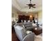 Spacious living room with open floor plan, a large sofa, and a view of the kitchen at 1802 Hartford Path, The Villages, FL 32162