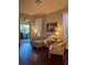 Comfortable living room with hardwood floors, neutral furniture, and a serene ambiance with natural lighting at 1802 Hartford Path, The Villages, FL 32162