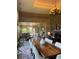 Open-concept area with multiple rooms including a dining area, living area, and fireplace at 1802 Hartford Path, The Villages, FL 32162