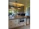 Multiple bright living spaces with open layouts, rustic wood accents, stone fireplace, and lots of seating at 1802 Hartford Path, The Villages, FL 32162