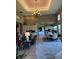 Large open living spaces with wood accents, living room, dining room, and kitchen in the background at 1802 Hartford Path, The Villages, FL 32162