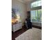 Cozy sitting area with a large window, modern art, and a comfortable massage chair at 1802 Hartford Path, The Villages, FL 32162